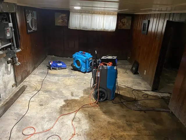 Dehumidifier and air mover drying a basement in Columbia, MD